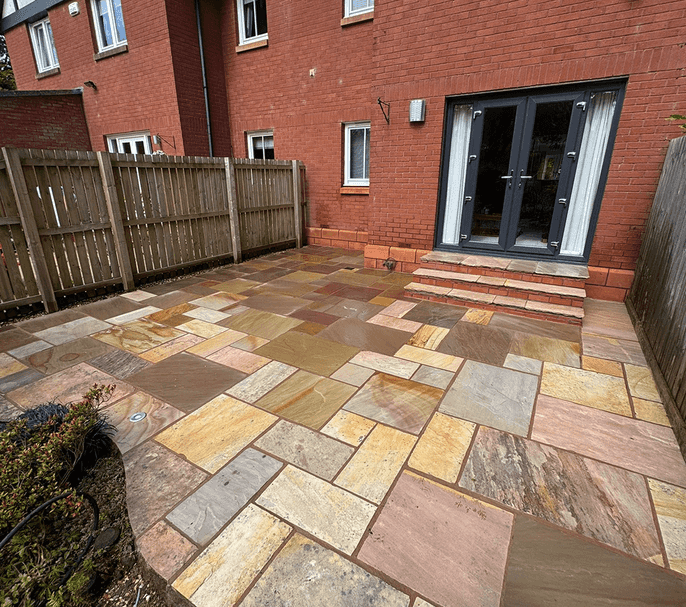 More modern type of red bricked semi detached property with a clean patio after it has been power washed